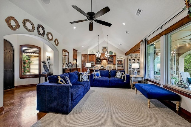 2600 Grapevine Springs Cv, Georgetown, TX 78628 - living room featuring ceiling fan, baseboards, arched walkways, wood finished floors, and a chandelier