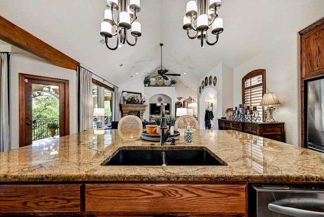 2600 Grapevine Springs Cv, Georgetown, TX 78628 - kitchen with a sink, a chandelier, dishwashing machine, light stone counters, and lofted ceiling