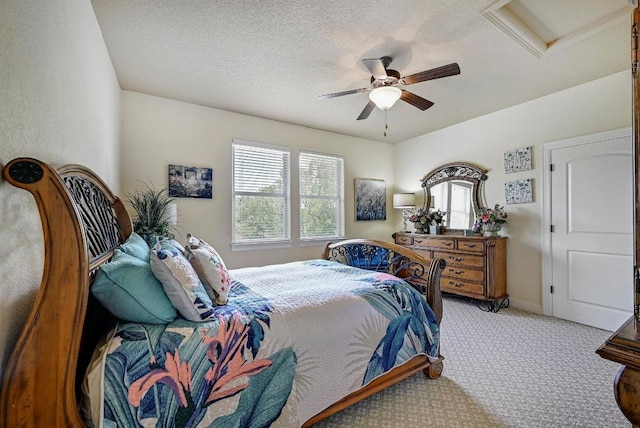 2600 Grapevine Springs Cv, Georgetown, TX 78628 - bedroom with multiple windows, carpet flooring, ceiling fan, a textured ceiling, and attic access