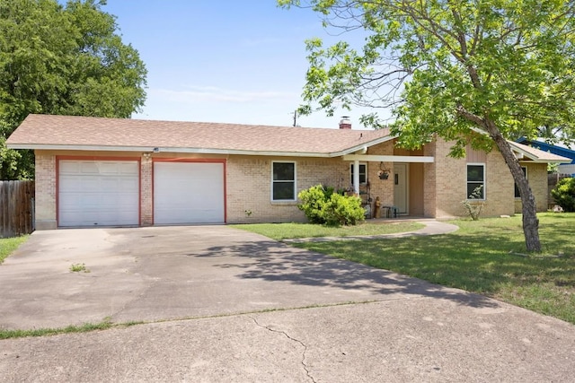 view of front of house with an attached garage, concrete driveway, brick siding, and a chimney