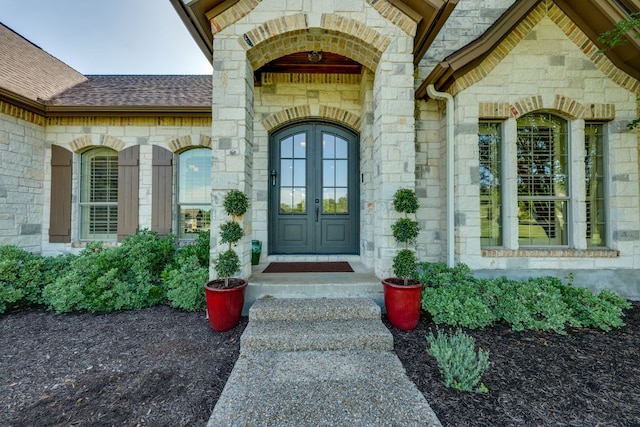 1186 Ranchers Club Ln, Driftwood, TX 78619 - entrance to property featuring stone siding, roof with shingles, and french doors