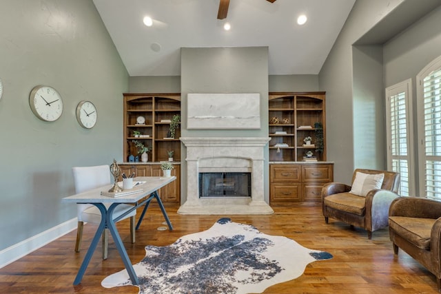 1186 Ranchers Club Ln, Driftwood, TX 78619 - living room with vaulted ceiling, a premium fireplace, wood finished floors, ceiling fan, and baseboards