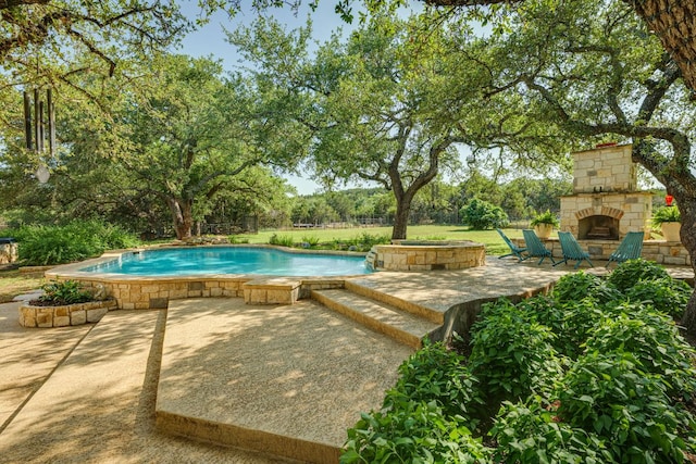 1186 Ranchers Club Ln, Driftwood, TX 78619 - outdoor pool featuring an outdoor stone fireplace and a patio area