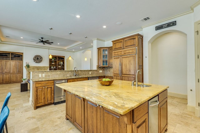 1186 Ranchers Club Ln, Driftwood, TX 78619 - kitchen with a sink, stone tile flooring, brown cabinetry, a center island, and recessed lighting