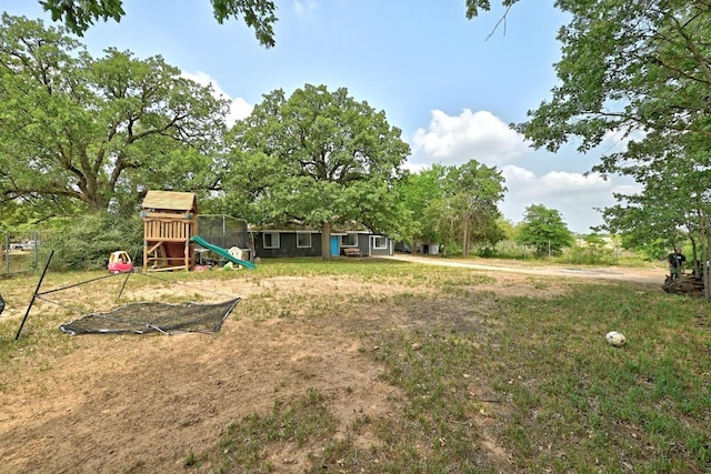 136 Shadow Oak Dr, Bastrop, TX 78602 - view of grassy yard featuring a playground