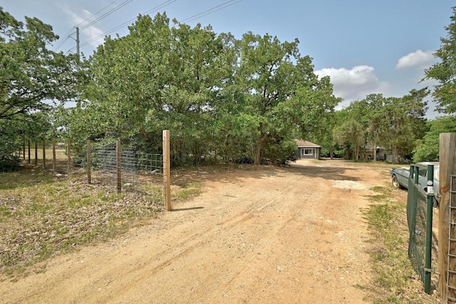 136 Shadow Oak Dr, Bastrop, TX 78602 - view of dirt / gravel road with a gated entry