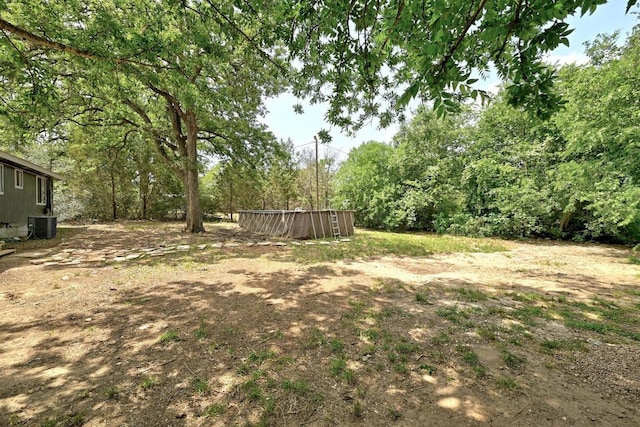 136 Shadow Oak Dr, Bastrop, TX 78602 - view of yard featuring central air condition unit