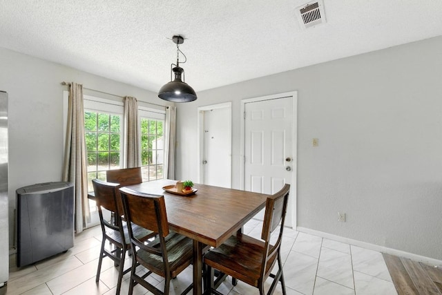 136 Shadow Oak Dr, Bastrop, TX 78602 - dining space featuring baseboards and a textured ceiling