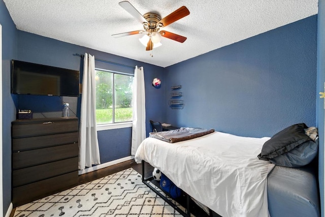 136 Shadow Oak Dr, Bastrop, TX 78602 - bedroom with a textured ceiling, wood finished floors, a ceiling fan, and baseboards