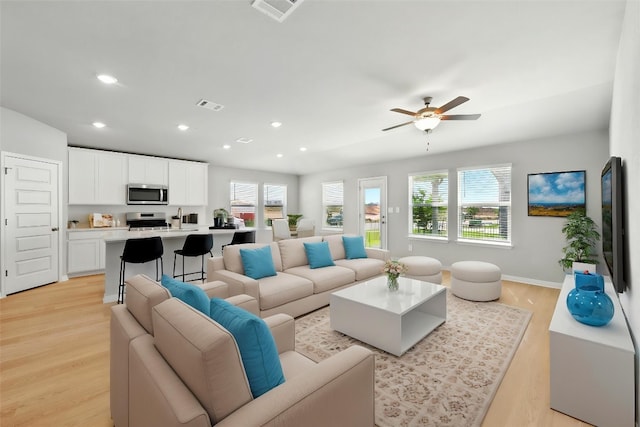 17129 Loch Rd, Pflugerville, TX 78660 - living room featuring plenty of natural light, light wood-style floors, ceiling fan, and recessed lighting