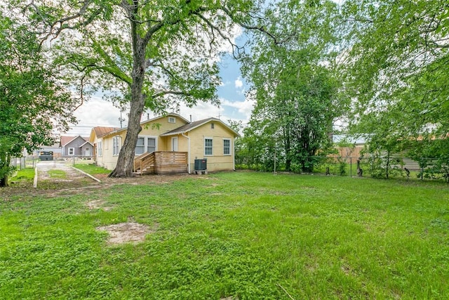 view of yard with a wooden deck and cooling unit
