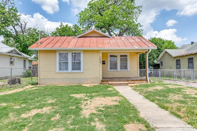 bungalow with a standing seam roof and a porch