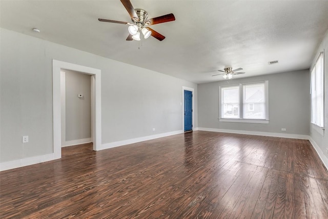 unfurnished living room featuring ceiling fan, wood finished floors, and baseboards