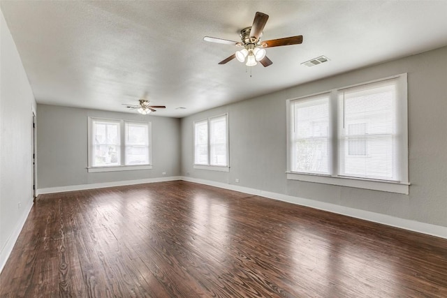 unfurnished room featuring a ceiling fan, wood finished floors, and baseboards