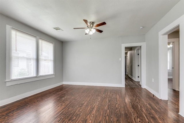 empty room featuring a ceiling fan, wood finished floors, and baseboards