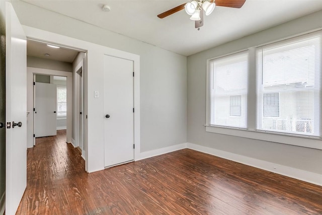 unfurnished room with wood finished floors, ceiling fan, baseboards, and a smoke detector