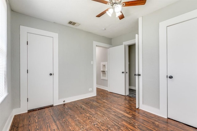 unfurnished bedroom featuring wood finished floors, baseboards, and ceiling fan