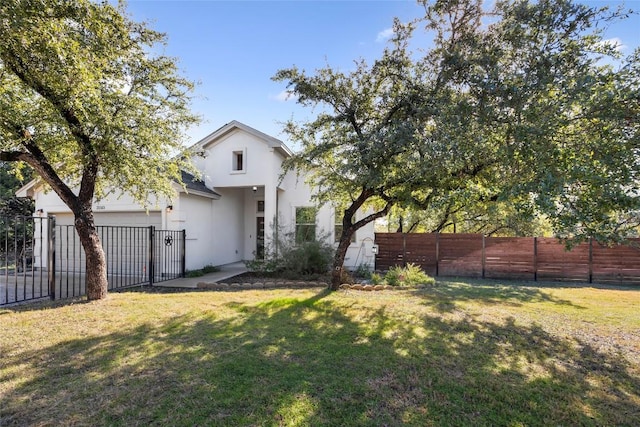 rear view of house with an attached garage and stucco siding