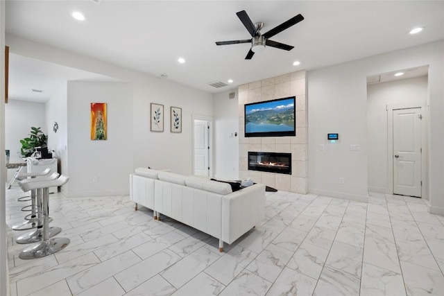 21513 Santa Carlo Ave, Lago Vista, TX 78645 - living area with light marble finish floors, a tile fireplace, recessed lighting, and a ceiling fan