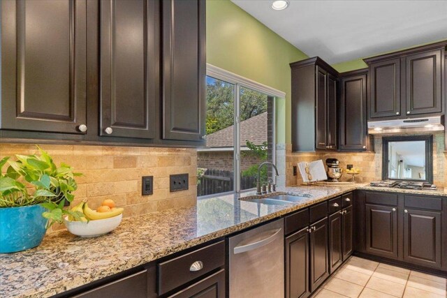 2932 Persimmon Valley Trl, Austin, TX 78732 - kitchen with a sink, stainless steel appliances, under cabinet range hood, light stone counters, and dark brown cabinets
