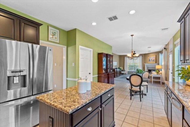 2932 Persimmon Valley Trl, Austin, TX 78732 - kitchen with stainless steel fridge with ice dispenser, open floor plan, a chandelier, light stone countertops, and a kitchen island