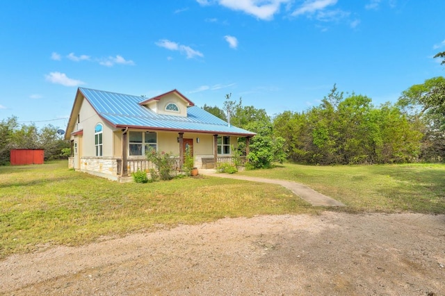195 Live Oak, Liberty Hill, TX 78642 - view of front of home featuring covered porch, a front yard, metal roof, and stone siding