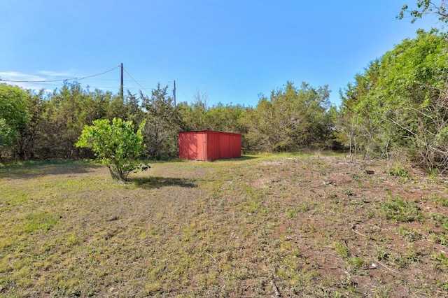 195 Live Oak, Liberty Hill, TX 78642 - view of grassy yard featuring an outbuilding and a storage shed