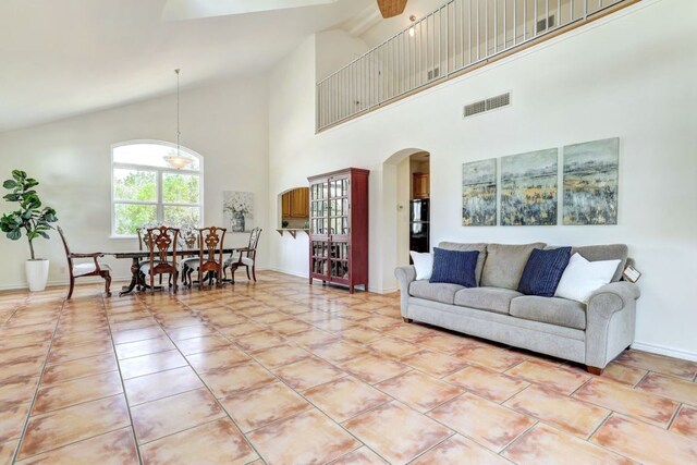 195 Live Oak, Liberty Hill, TX 78642 - living area featuring high vaulted ceiling, arched walkways, and baseboards