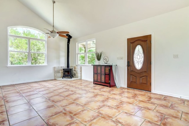 195 Live Oak, Liberty Hill, TX 78642 - foyer with a wood stove, ceiling fan, lofted ceiling, and baseboards