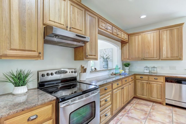 195 Live Oak, Liberty Hill, TX 78642 - kitchen with stainless steel appliances, under cabinet range hood, light tile patterned floors, light stone counters, and recessed lighting
