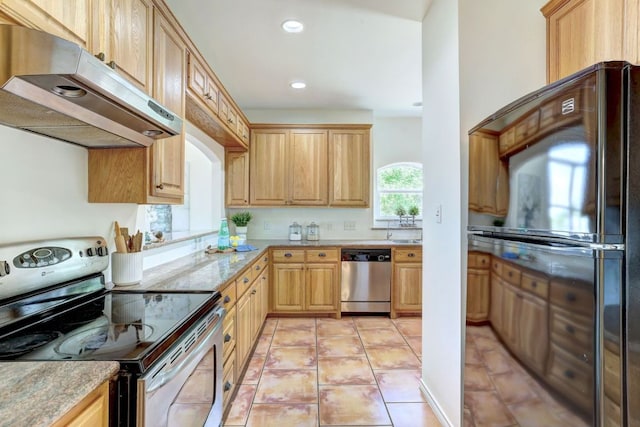 195 Live Oak, Liberty Hill, TX 78642 - kitchen with appliances with stainless steel finishes, under cabinet range hood, recessed lighting, light tile patterned floors, and light brown cabinetry