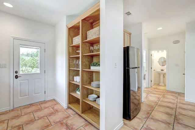 195 Live Oak, Liberty Hill, TX 78642 - entryway with light tile patterned flooring, baseboards, recessed lighting, and a sink