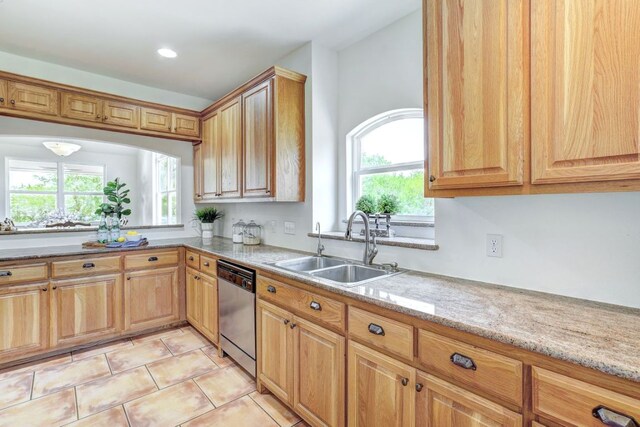 195 Live Oak, Liberty Hill, TX 78642 - kitchen featuring dishwasher, a sink, light stone counters, light tile patterned floors, and recessed lighting
