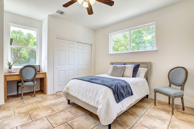 195 Live Oak, Liberty Hill, TX 78642 - bedroom featuring multiple windows, light tile patterned floors, a closet, and a ceiling fan