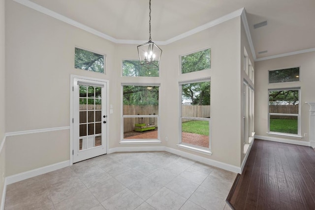 3408 Reims Ct, Austin, TX 78738 - unfurnished dining area with crown molding, baseboards, a towering ceiling, a chandelier, and tile patterned flooring