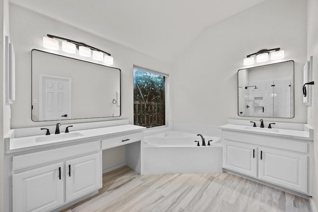 3408 Reims Ct, Austin, TX 78738 - full bathroom featuring vaulted ceiling, a bath, two vanities, and a tile shower