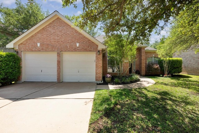 view of front of property featuring brick siding, a garage, and a front yard
