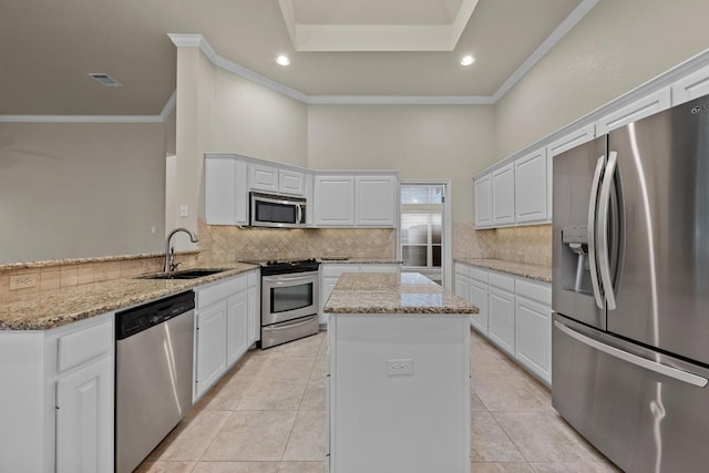 3408 Reims Ct, Austin, TX 78738 - kitchen with stainless steel appliances, tasteful backsplash, a kitchen island, a peninsula, and white cabinets