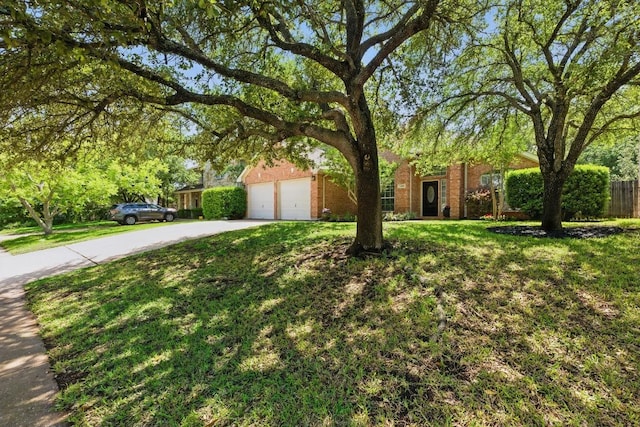 3408 Reims Ct, Austin, TX 78738 - obstructed view of property featuring driveway, brick siding, and a garage
