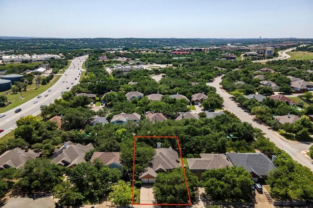 aerial perspective of suburban area featuring property boundaries highlighted and a major roadway