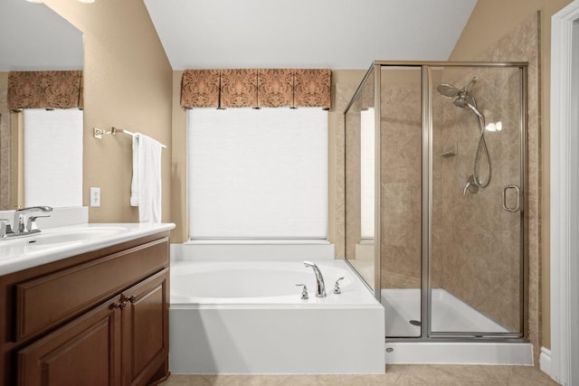 bathroom with a stall shower, a bath, vanity, and tile patterned floors