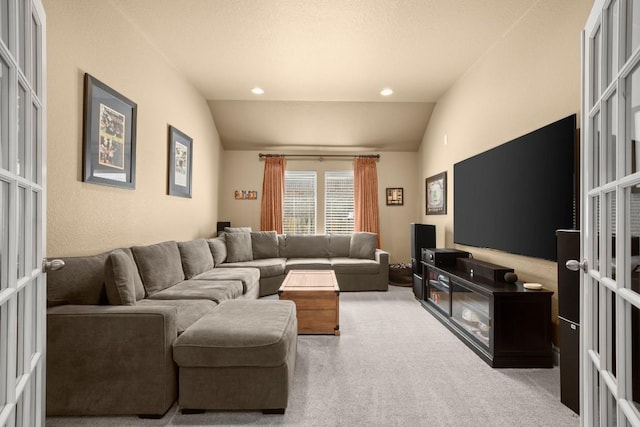 living room with lofted ceiling, carpet floors, and french doors