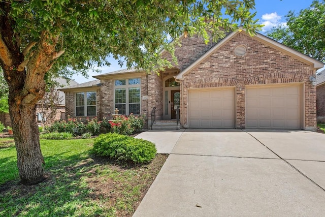 view of front of home featuring brick siding, an attached garage, and driveway
