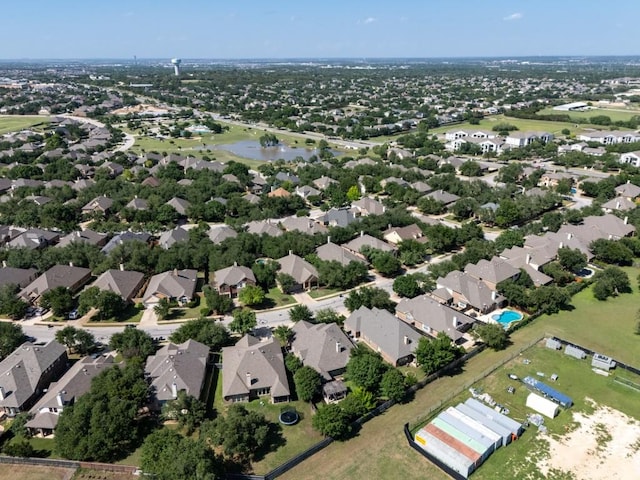 view of property location featuring a nearby body of water and nearby suburban area