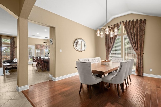 dining area featuring wood-type flooring, vaulted ceiling, baseboards, and recessed lighting