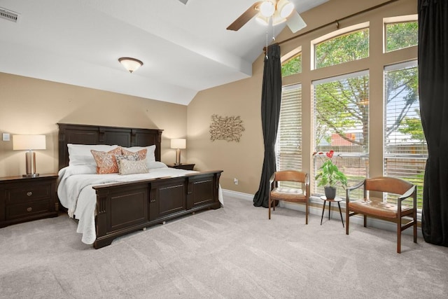 bedroom featuring lofted ceiling, light carpet, and baseboards