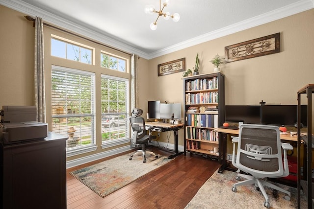 office area featuring wood finished floors, ornamental molding, a chandelier, and baseboards