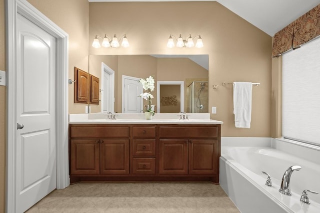 bathroom with lofted ceiling, a stall shower, a bath, double vanity, and tile patterned flooring