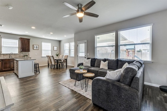 living area with ceiling fan, baseboards, dark wood finished floors, and recessed lighting