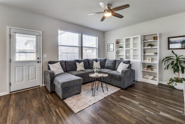 living area featuring a ceiling fan, dark wood-style floors, and baseboards